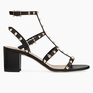 Valentino Garavani Rockstud calfskin leather sandals.
Platinum-finish studs
Adju
